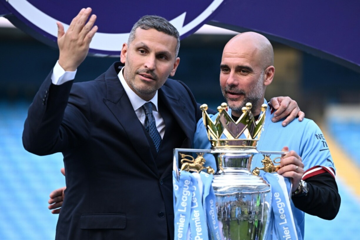 Manchester City's then-manager Pep Guardiola (R) with the club's Emirati chairman Khaldoon al-Mubarak at the presentation of the Premier League trophy in 2023