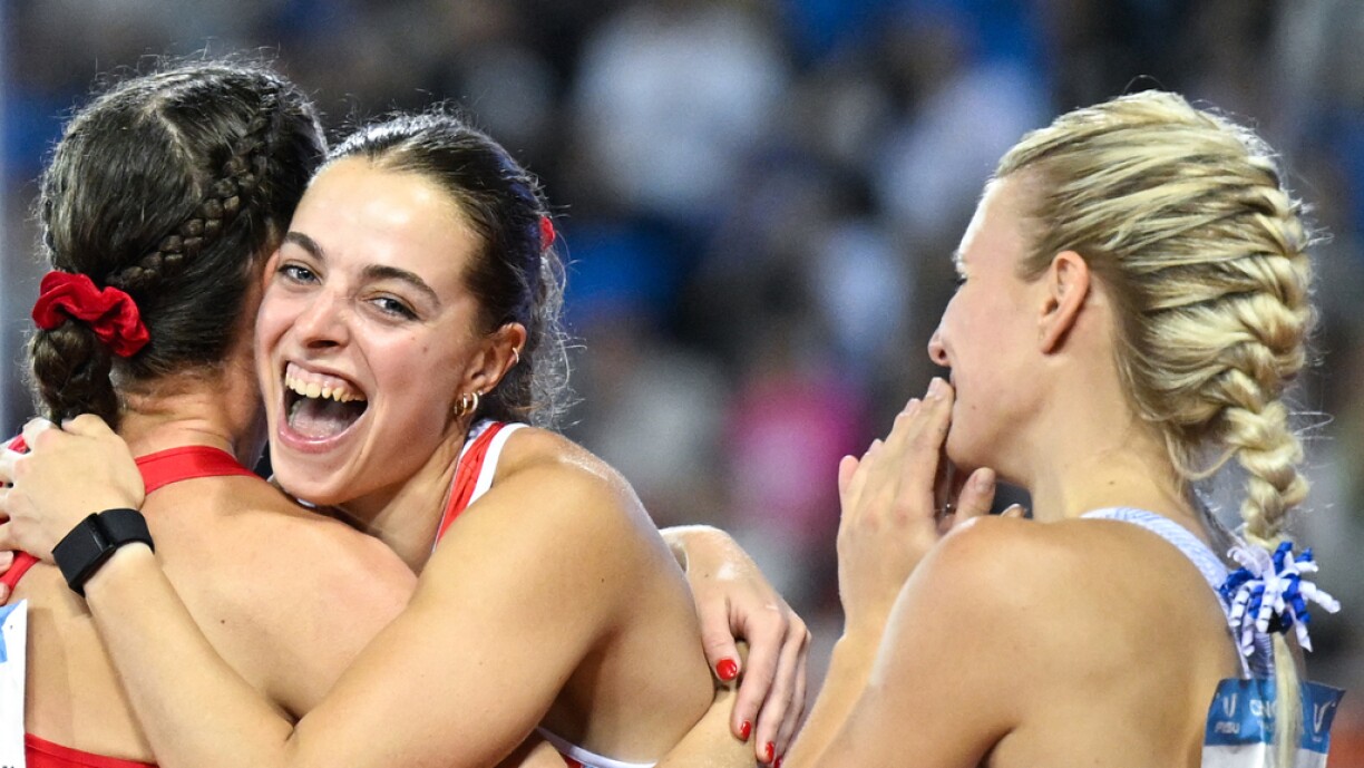 Patrizia van der Weken (centre) celebrates after the women's 100m final at the 31st FISU Summer World University Games in Chengdu on 2 August 2023.