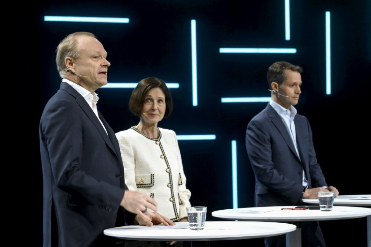 Nokia chief executive Pekka Lundmark (L) stands next to chairwoman Sari Baldauf (C) and his successor Justin Hotard (R), the head of AI at Intel