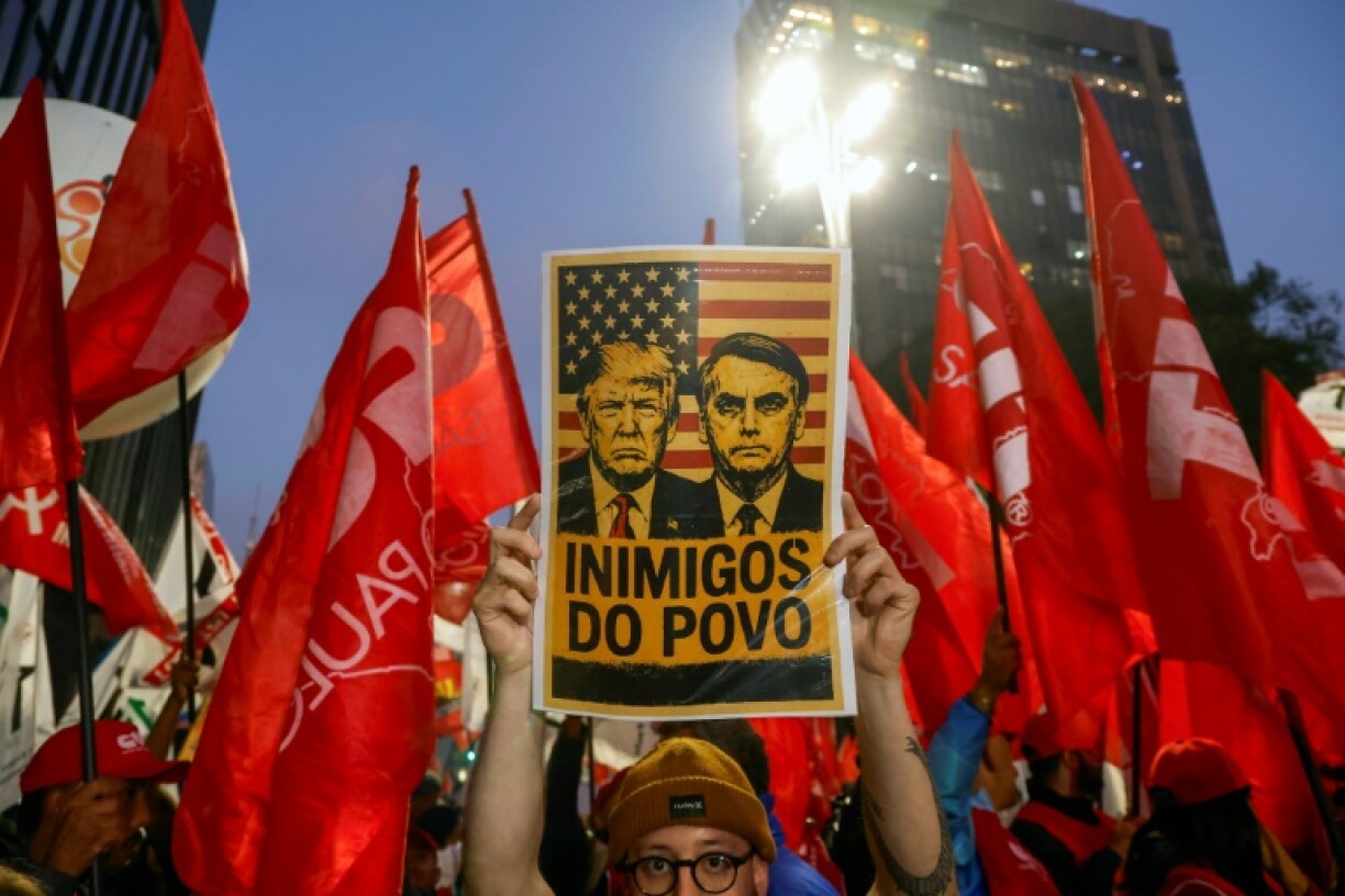 A poster declaring US President Donald Trump and former Brazilian President Jair Bolsonaro 'Enemies of the people' at a demonstration in Sao Paulo