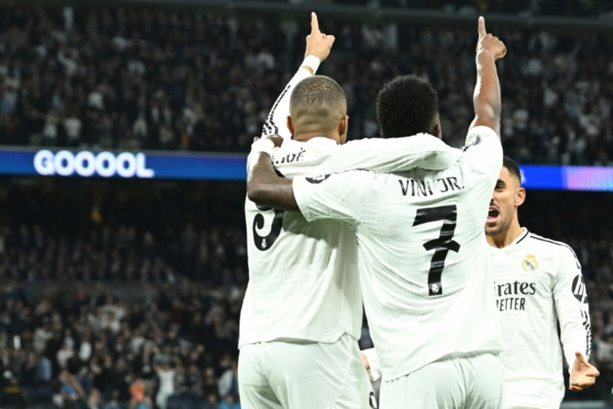 Real Madrid's French forward Kylian Mbappe celebrates with Vinicius Junior during the win over Manchester City