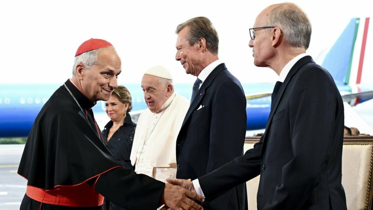 Visit of Pope Francis to Luxembourg: Prime Minister Frieden shakes hands with Cardinal Robert Francis Prevost.