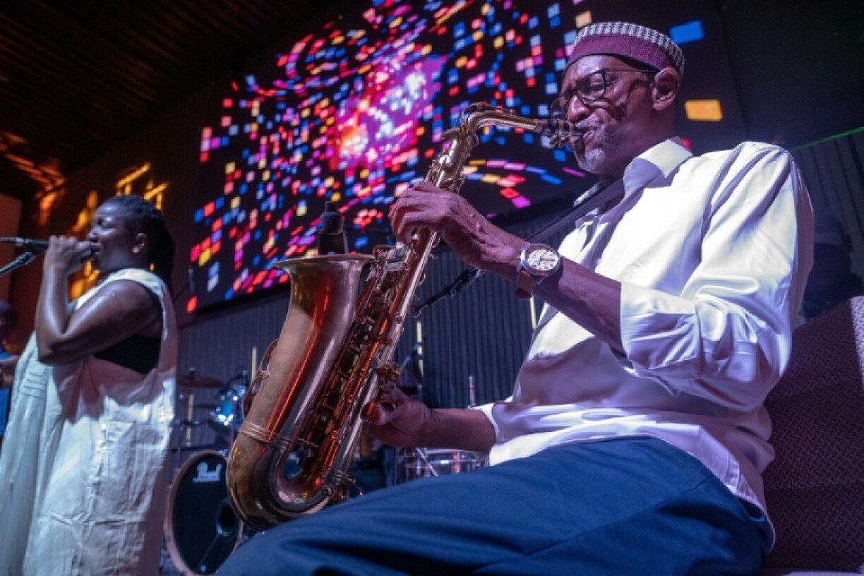 Orchestra Baobab saxophonist Thierno Koite performs alongside vocalist Korka Dieng during a concert at the Dakar nightclub Just for You in September 2026