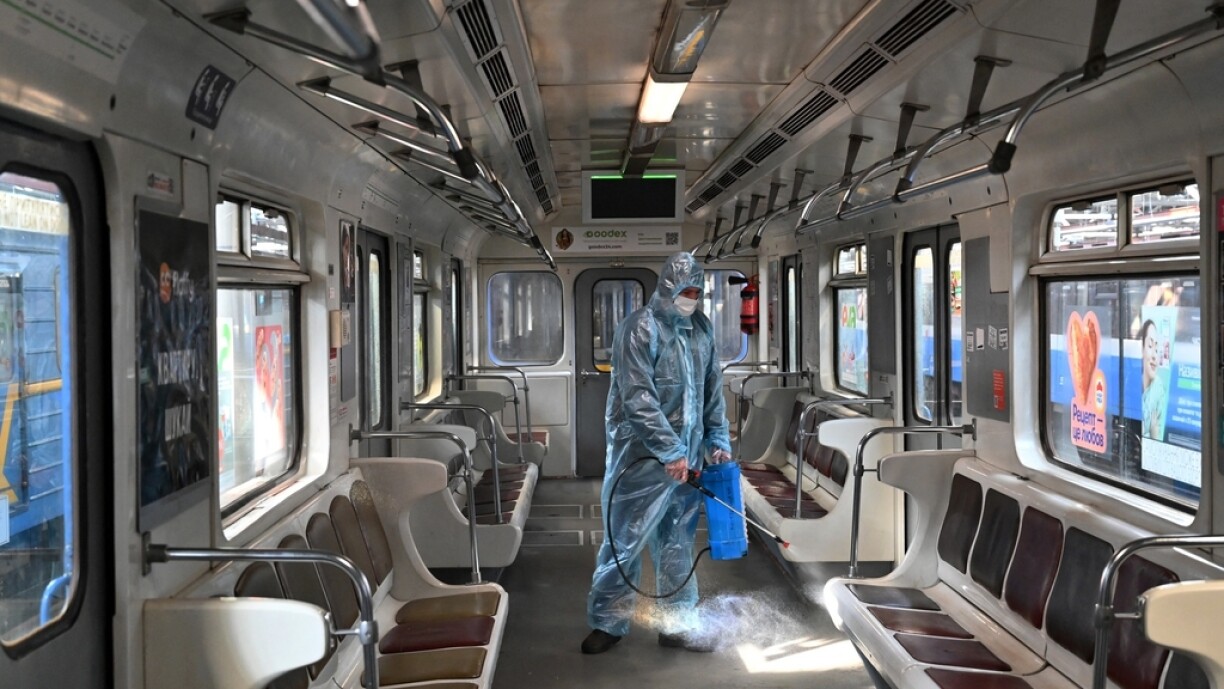 An employee wearing a protective suit disinfects a metro carriage in Kiev on November 8, 2021, amid the ongoing coronavirus disease (Covid-19) pandemic.