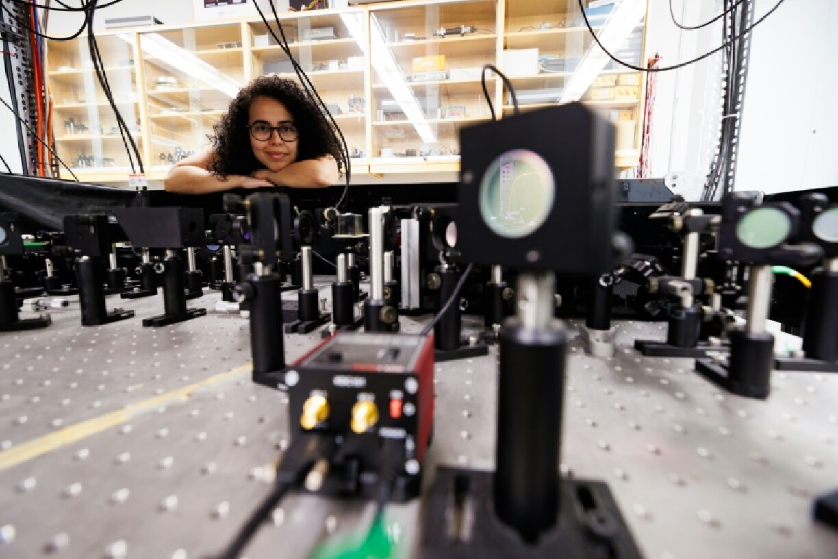 Experimental physicist Daniela Angulo poses with an apparatus in the physics lab at the University of Toronto