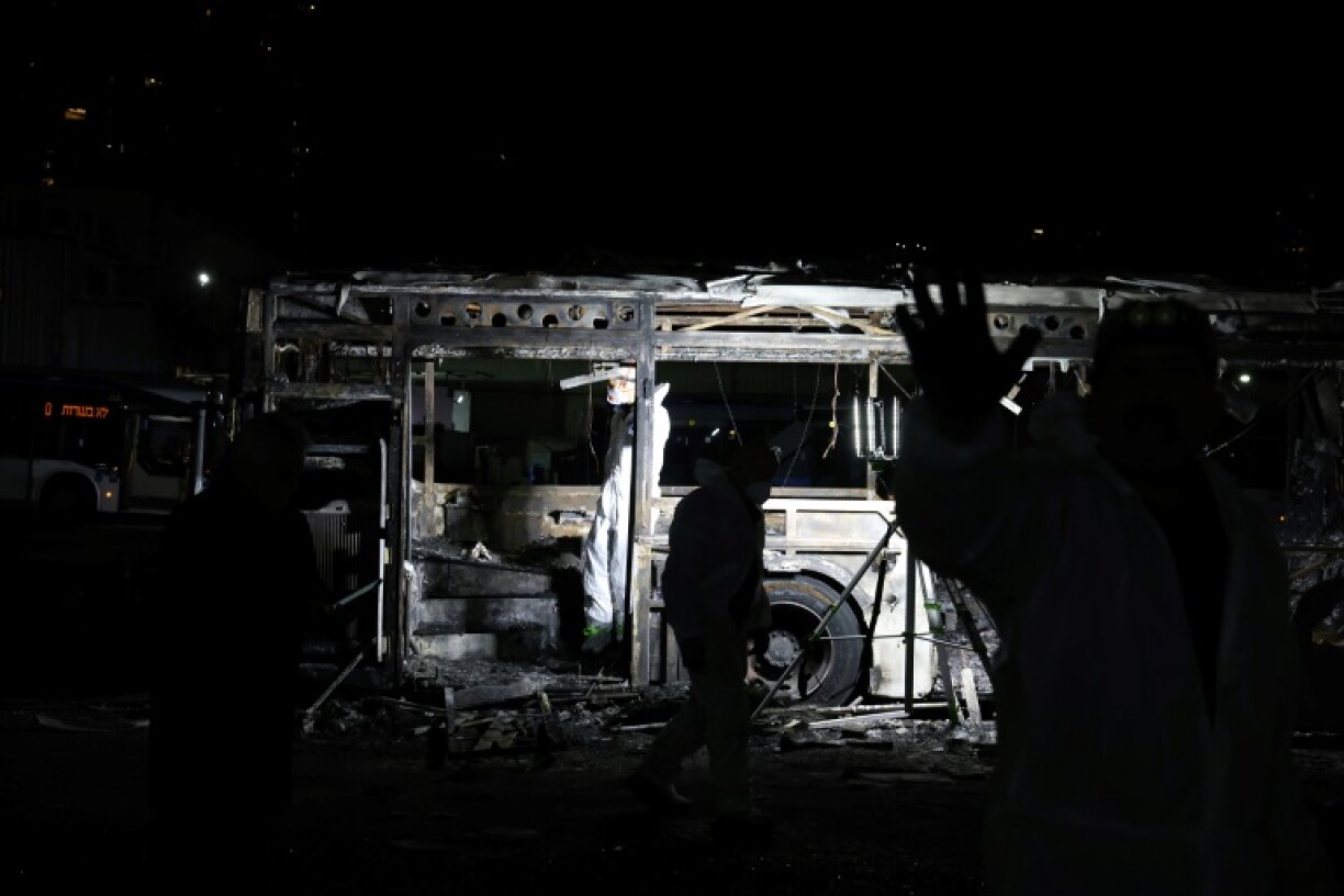 Security forces and bomb disposal units are deployed to the scene of a bus explosion in Israel