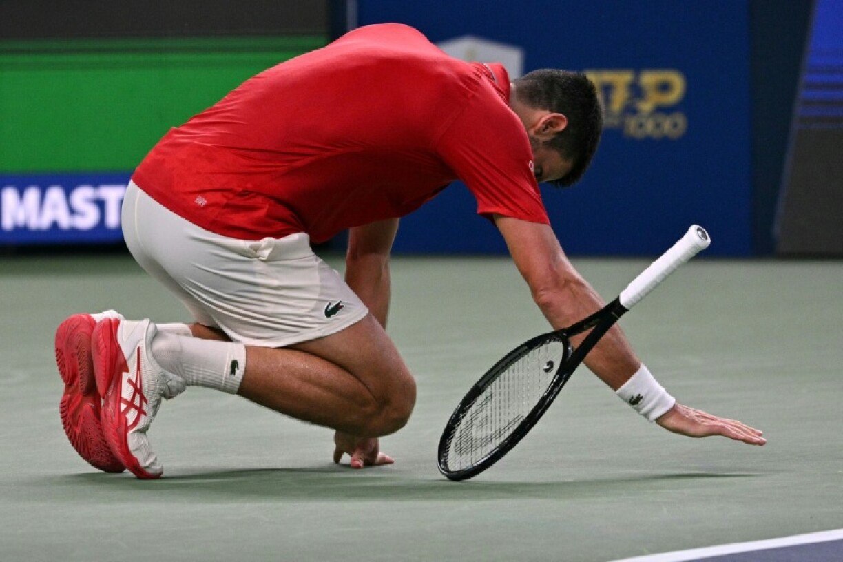 Novak Djokovic falls to the court in Shanghai
