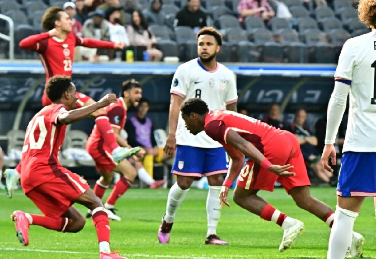 Canadian forward Jonathan David (right) wheels away after scoring his team's winning goal against the United States