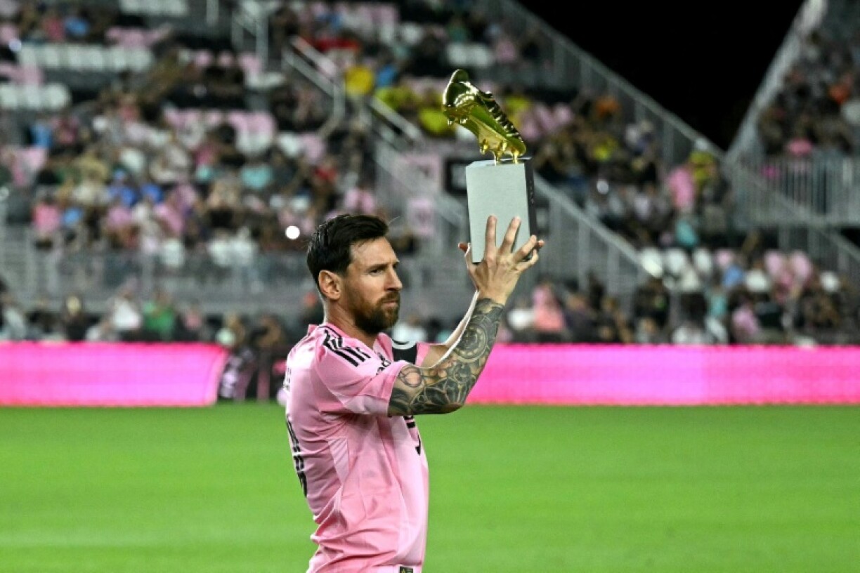 Lionel Messi poses with the MLS Golden Boot trophy after scoring 29 times in 28 games in the regular season