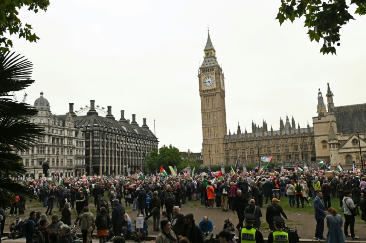 Protesters with placards and Palestinian flags gather in Parliament Square in London to demonstrate against Trump's state visit