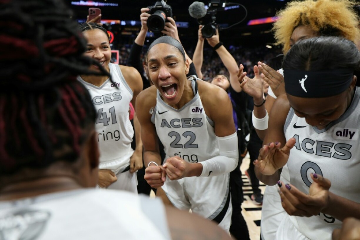A'ja Wilson, center, of the Las Vegas Aces celebrates after her club completed a sweep over Phoenix to win the WNBA title for a third crown in four seasons