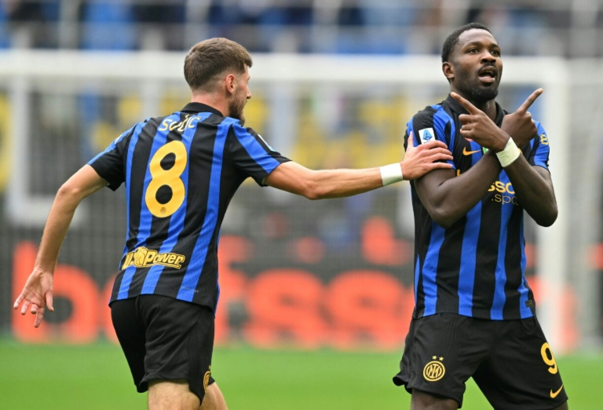 Marcus Thuram (R) brought Inter level late on before Piotr Zielinski snatched a 98th-minute winner