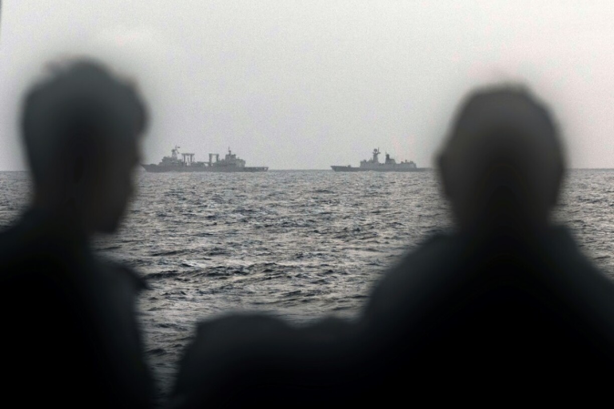Sailors aboard an Australian navy ship look out at Chinese vessels on February 13, picture by the Australian Defence Force