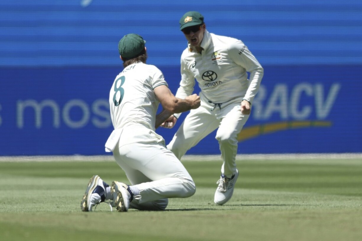 Australia's Mitchell Marsh (left) celebrates with Steve Smith after taking a catch to dismiss India captain Rohit Sharma