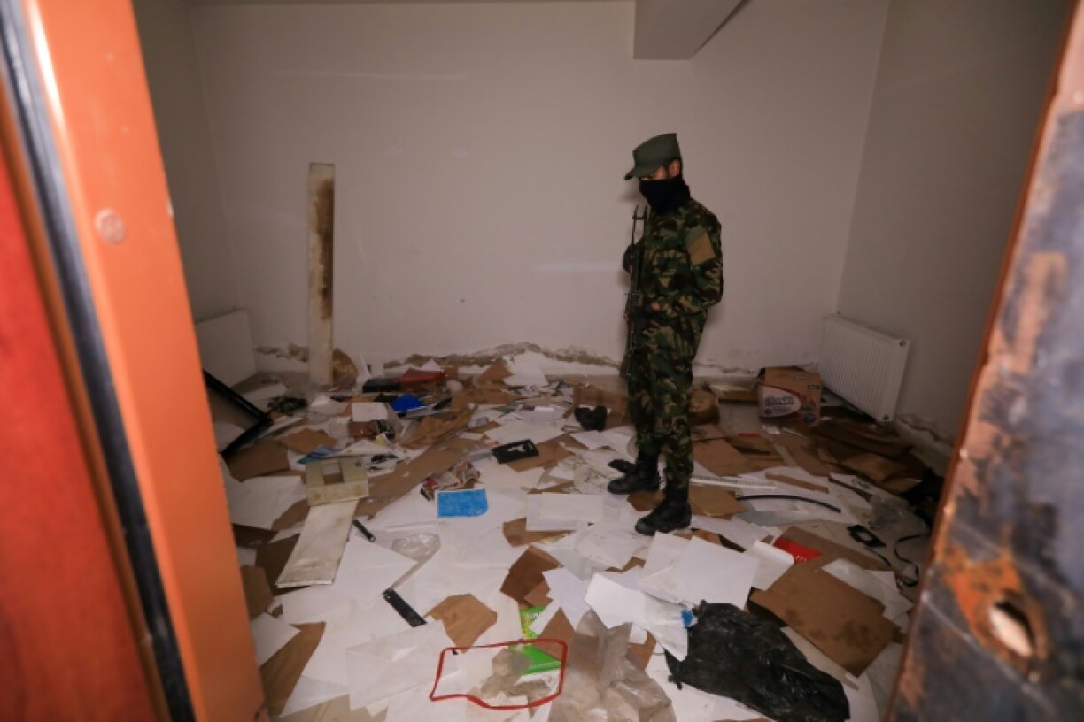 Piles of ransacked papers in a room in Maher al-Assad's private office in the hills above Damascus