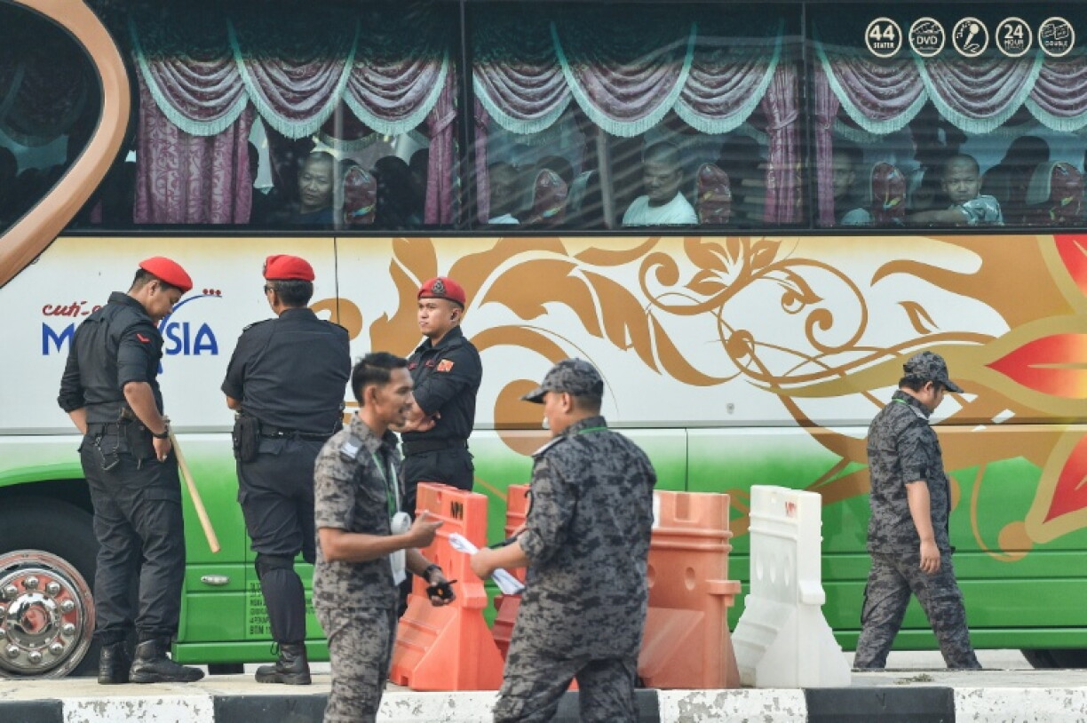 Dozens of buses arrived under police escort on Tuesday at the Majlis Perbandaran Manjung stadium near the Lumut naval base in northwestern Malaysia, AFP correspondents saw, where the migrants were to be processed