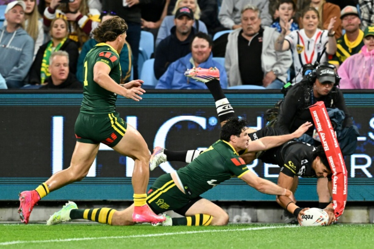 New Zealand’s Casey McLean (R) scores a spectacular try during their Rugby League World Cup match against Australia