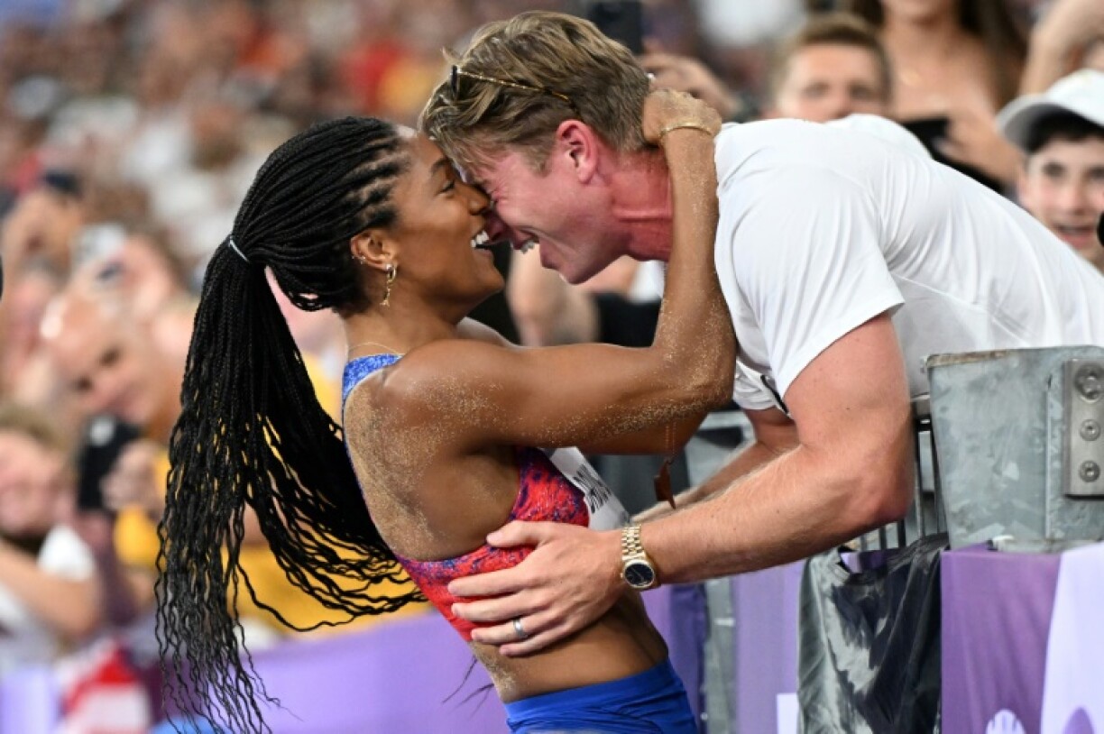 Tara Davis-Woodhall celebrates with her husband Hunter Woodhall after winning the women's long jump final