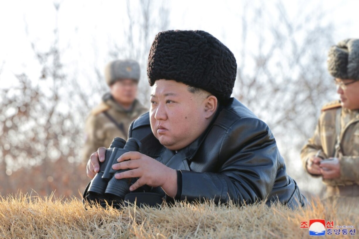 Images in North Korean state media showed Kim, flanked by officials, sporting binoculars and watching a missile destroy a small building, which erupts in flames