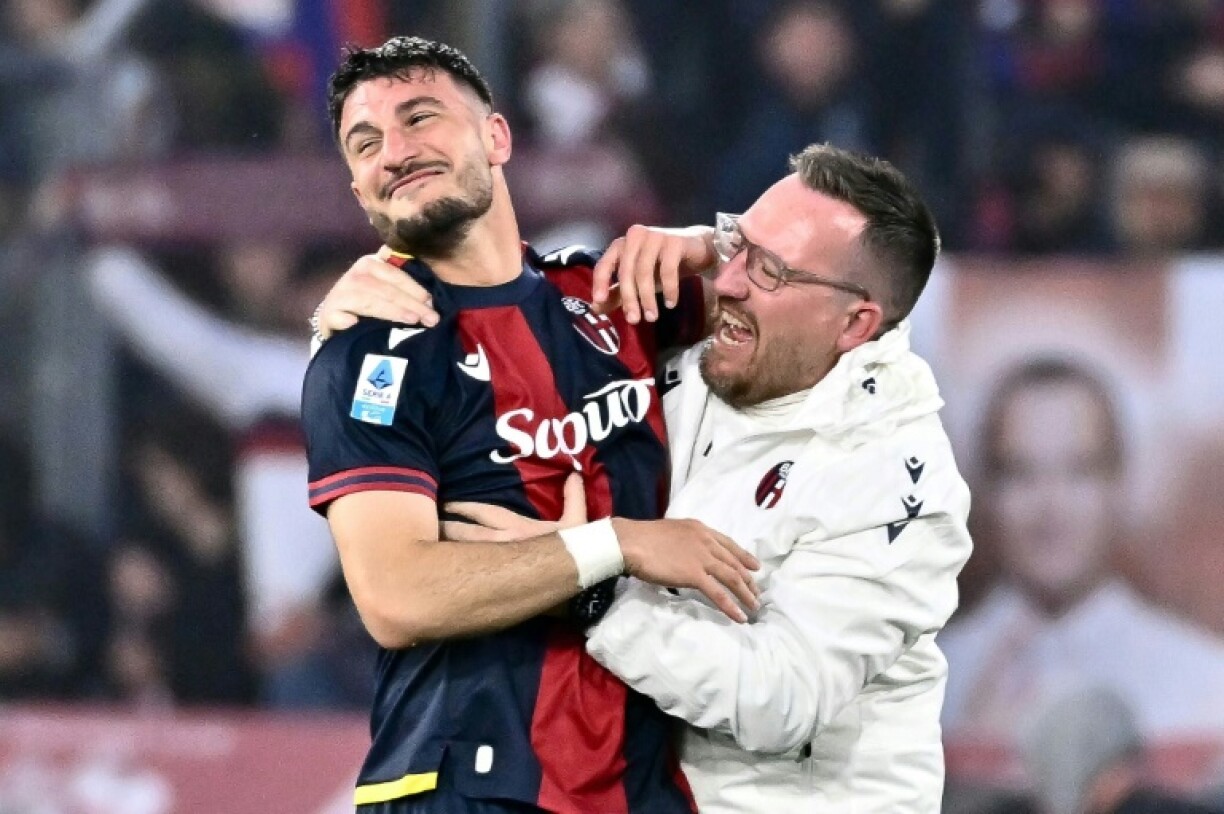 Riccardo Orsolini (L) celebrates scoring the winning goal for Bologna against Inter Milan