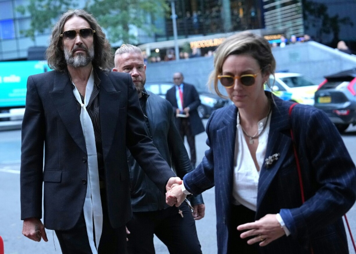 Brand arrived for the start of the case in a black Mercedes-Benz van accompanied by his wife Laura