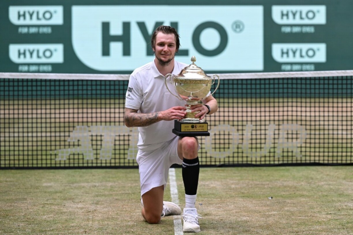 Kazakhstan's Alexander Bublik celebrates his second title on the grass of Halle, Germany