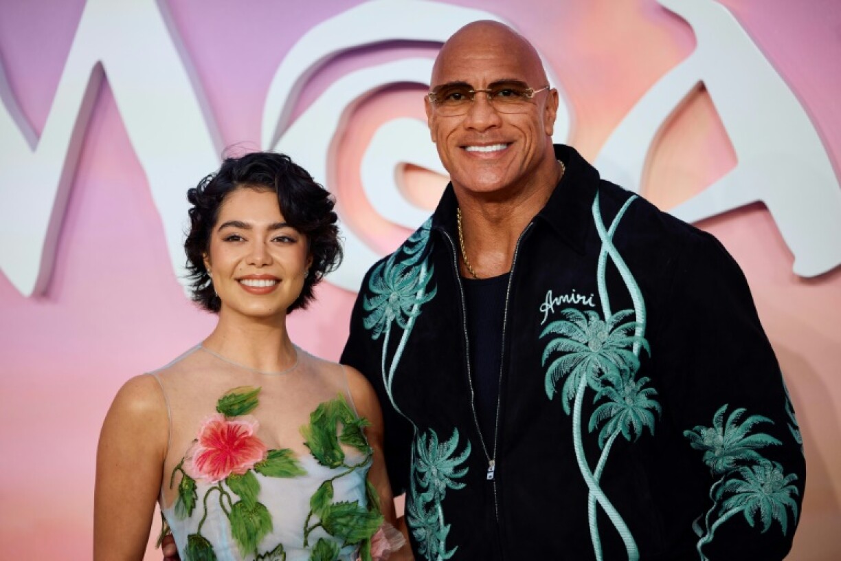 US actors Auli'i Cravalho (L) and Dwayne Johnson pose on the red carpet at the UK premier of