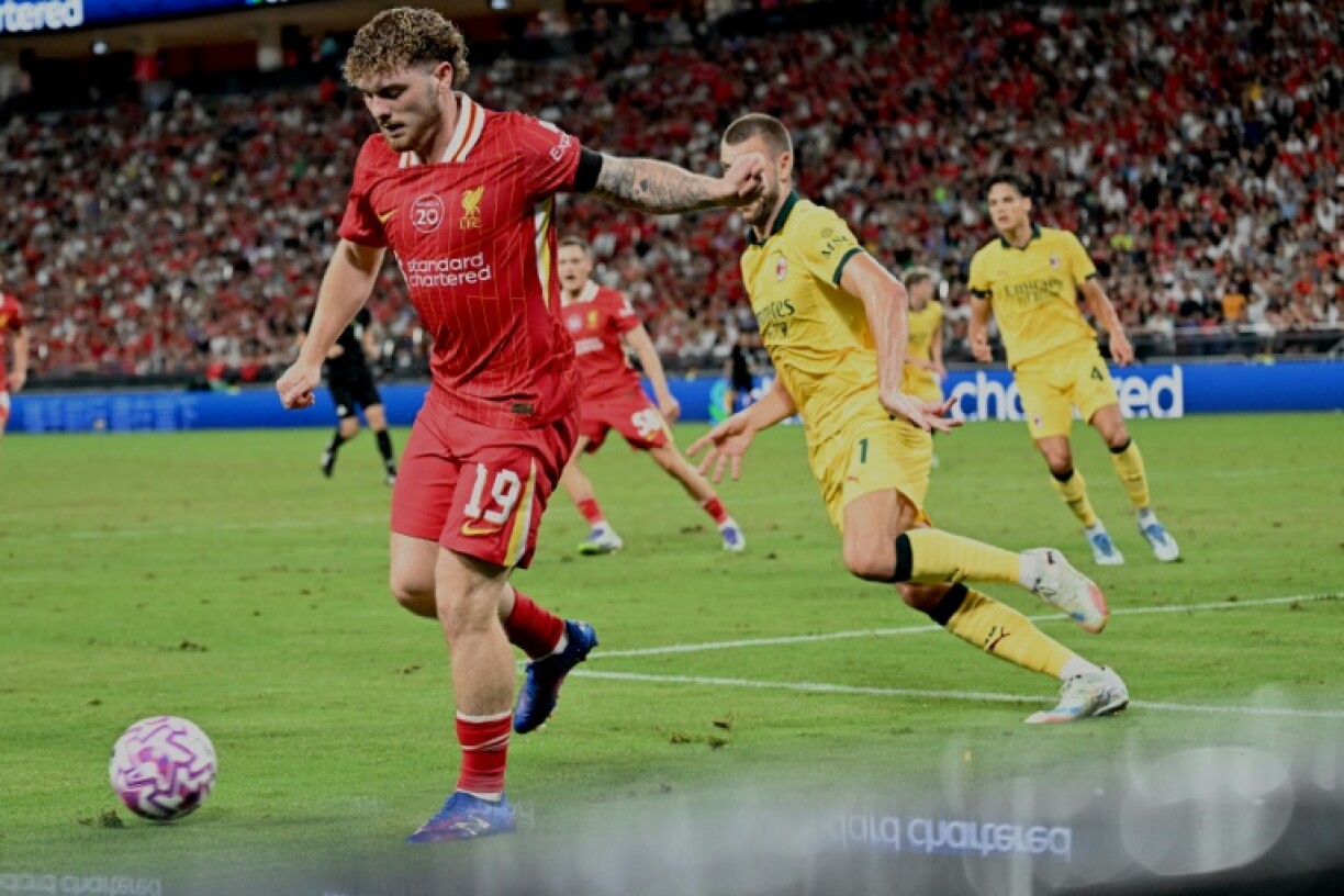 Liverpool's Harvey Elliott (L) defends against AC Milan during their friendly at the Kai Tak Stadium in Hong Kong
