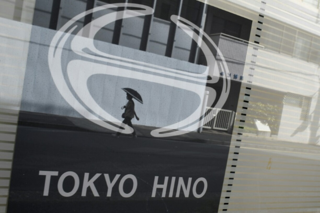 This photo taken in Tokyo in August 2022 shows the logo Japanese truck-maker Hino Motors, a arm of Toyota, reflected in glass