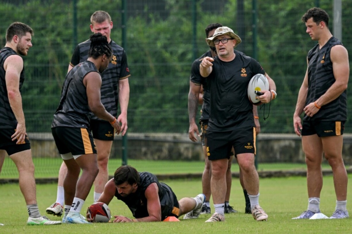 Kalinga Black Tigers' coach Mike Friday (second right) instructs players during training in Mumbai
