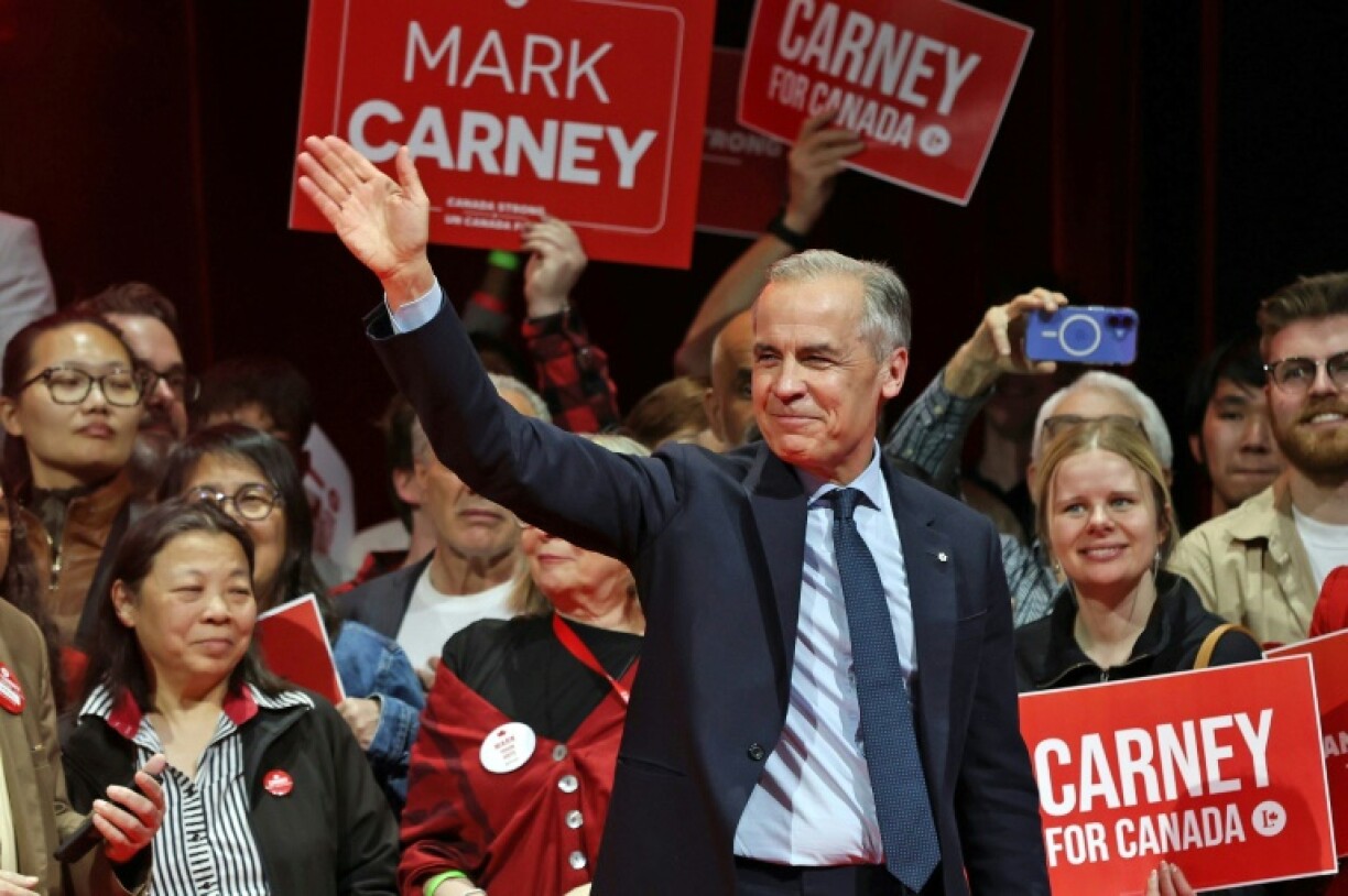 Canada's Prime Minister and Liberal Party leader Mark Carney waves to supporters at a victory party in Ottawa