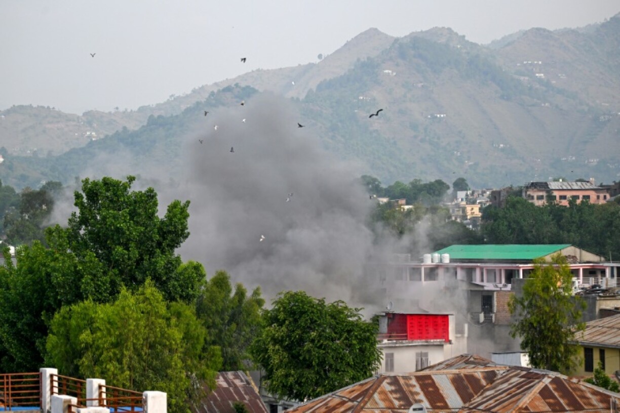 Smoke billows after an artillery shell landed in the main town of Poonch district in India's Jammu region on May 7, 2025