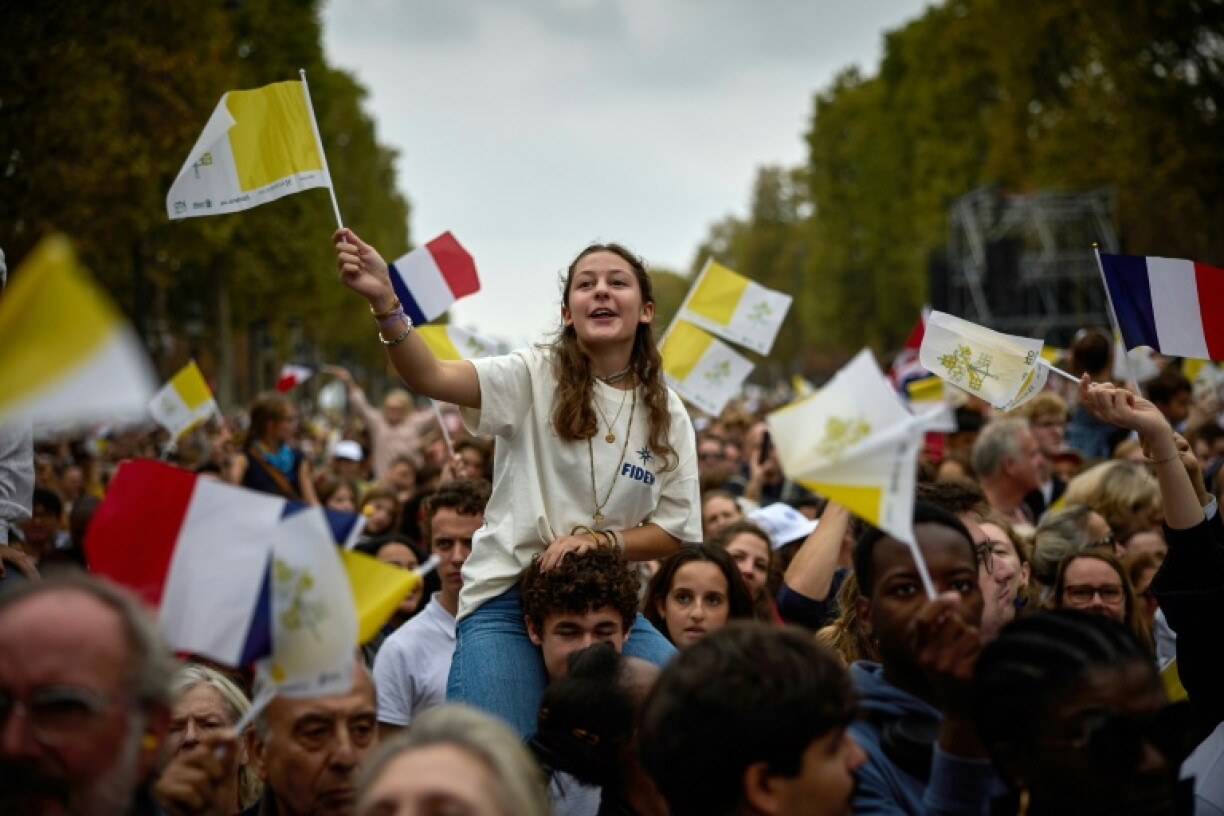 Helicopters could be heard flying overhead as worshippers waved small yeallow-and-white Vatican flags