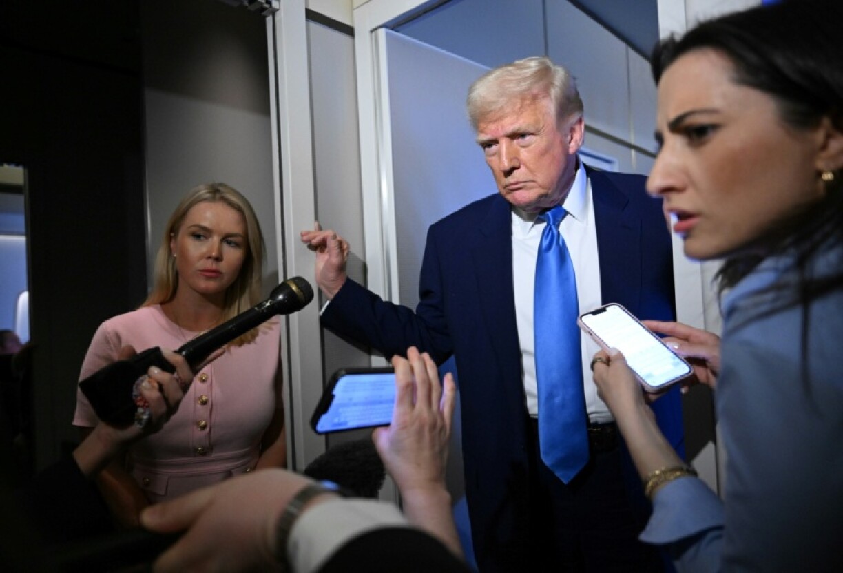 US President Donald Trump speaks to reporters while in flight on Air Force One, en route to Joint Base Andrews on April 6, 2025.