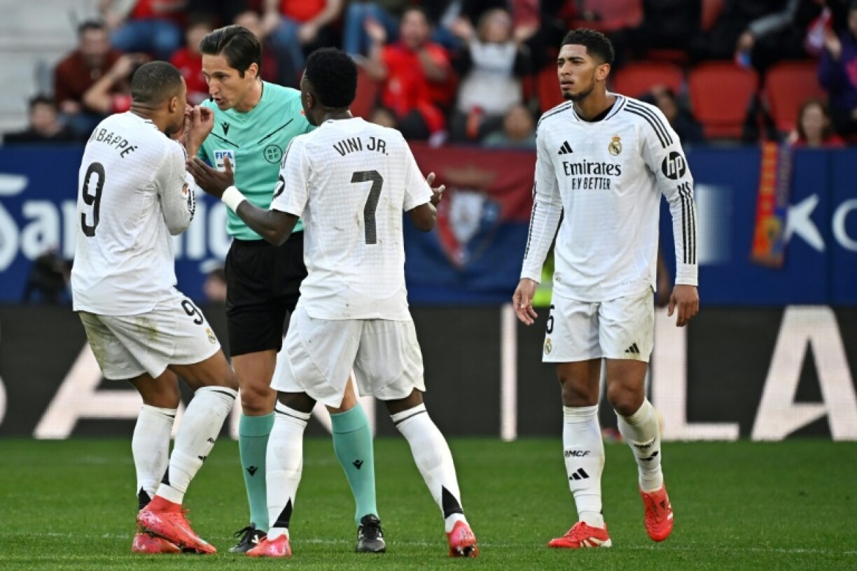 Flashpoint: Real Madrid's Kylian Mbappe and Vinicius Junior remonstrate with referee Jose Munuera over the red card given to Jude Bellingham (R)
