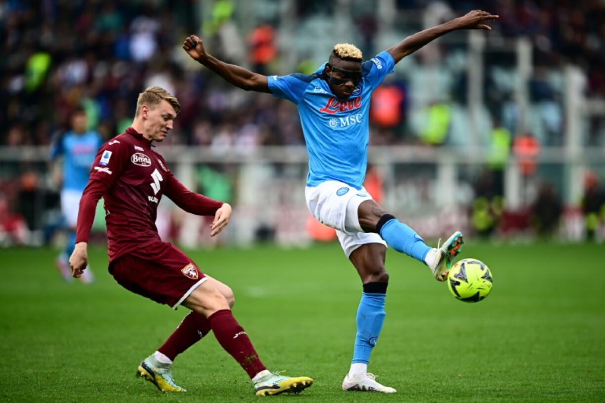 Le buteur de Naples Victor Osimhen (d) devant le défenseur du Torino Perr Schuurs, le 19 mars 2023 à Turin