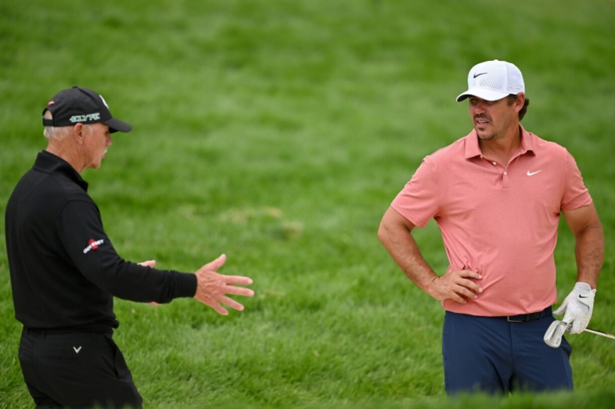 Five-time major winner Brooks Koepka of the United States, right, talks to coach Pete Cowen, left, during a practice round at Oakmont that helped Koepka fire a two-under par 68 to stand two off the lead at the US Open