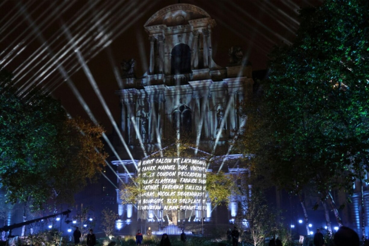 At a ceremony in central Paris, first responders slowly read out the names of those killed that Friday night