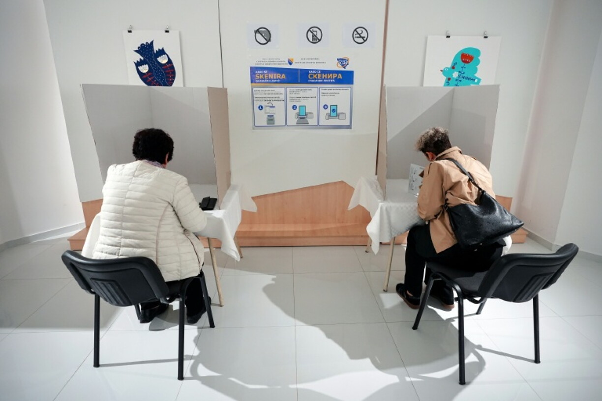 Voters fill out ballots as they vote in Bosnia and Herzegovina's general election at voting station in Laktasi, near Banja Luka