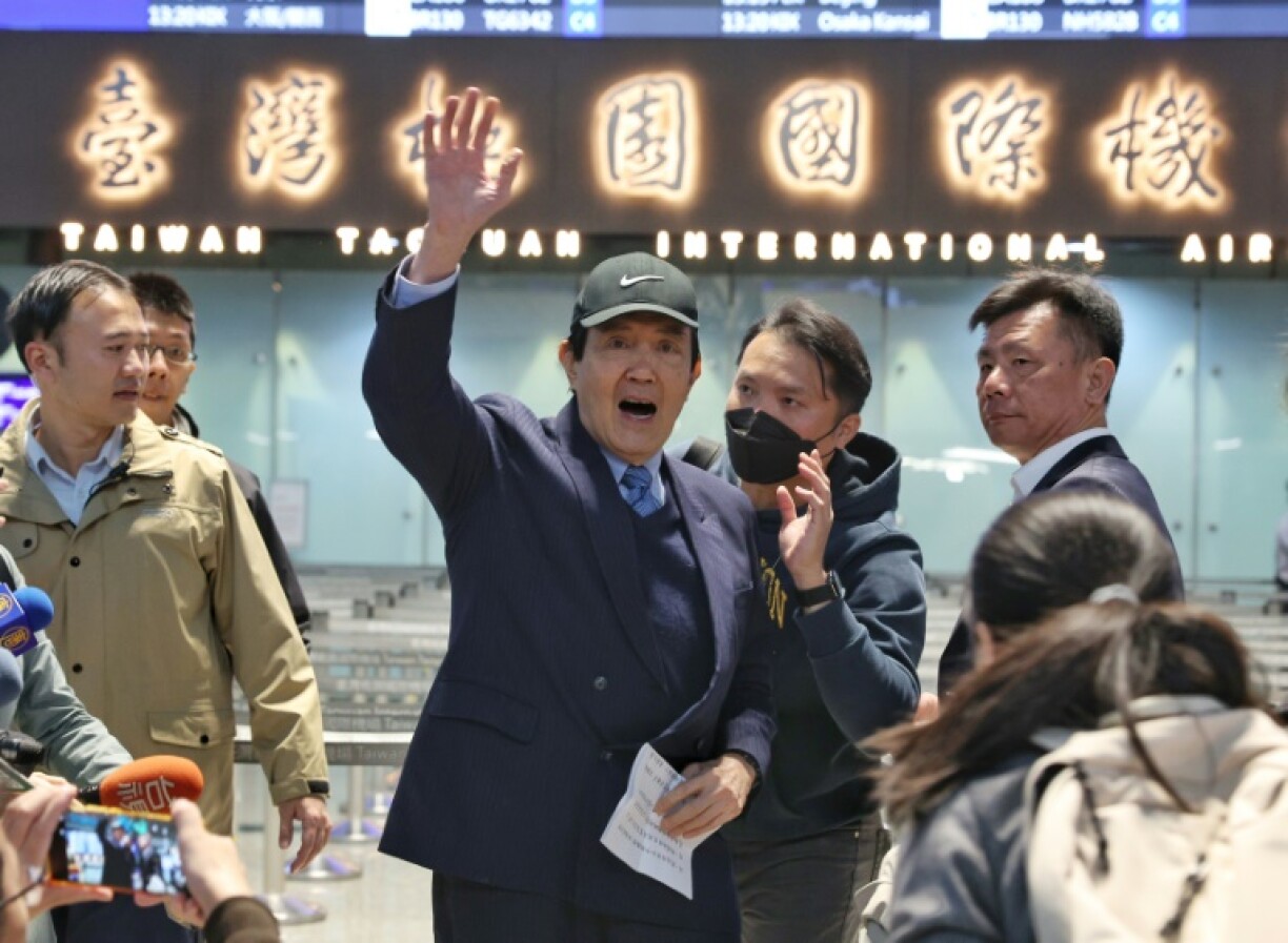 Former Taiwanese president Ma Ying-jeou waves to reporters before leading a delegation of students to China
