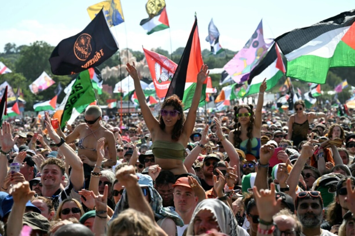 Thousands of festival-goers, many waving Palestinian flags, cheered the band