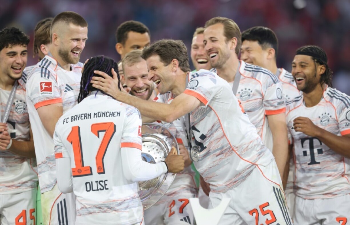 Bayern Munich's players congratulate Michael Olise after winning the league title.