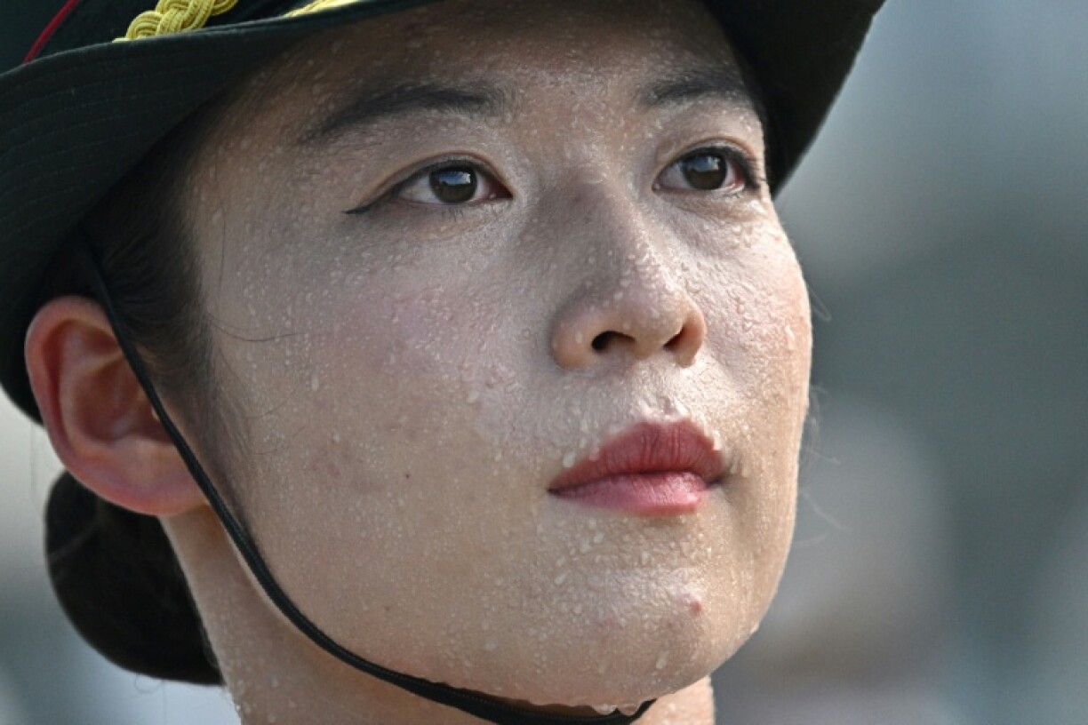 Pin-straight lines of Chinese soldiers took part in a rehearsal under the sweltering sun in Beijing to prepare for a military parade in September