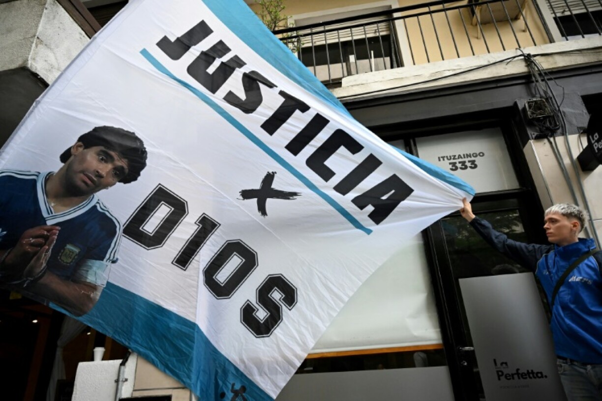 Fans held up banners calling for 'justice' outside the court hosting the trial of seven medical staff accused of homicide in Diego Maradona's death
