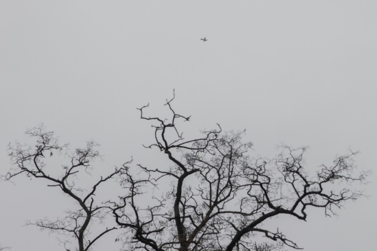 A drone flies over Ukrainian government buildings during an air alarm