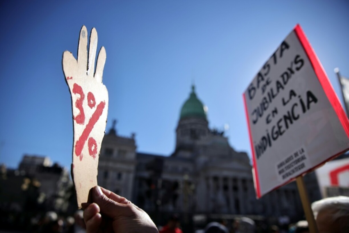 A protester holds a sign reading